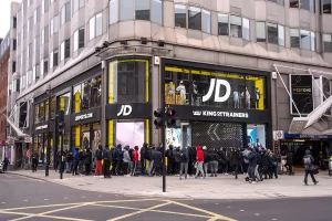 A large group of shoppers wait outside the entrance for the JD Sports store to open on London's Oxford Street on April 12, 2021. SOPA IMAGES/LIGHTROCKET VIA GETTY