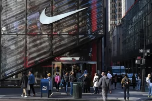 People walk past the Nike Store on Fifth Avenue in midtown Manhattan in New York.
